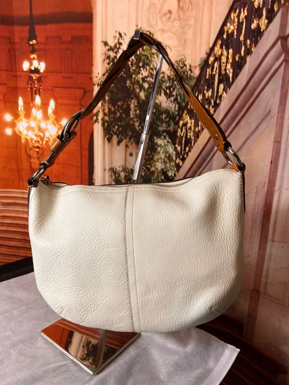 Coach Soho White Pebbled Leather Hobo bag features a distinctive braided handle